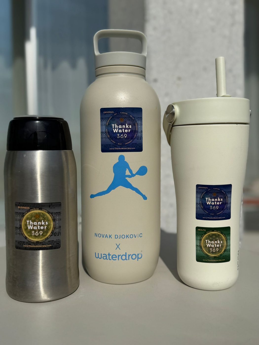 ThanksWater369 labels applied to reusable steel and insulated water bottles
