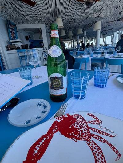 A labelled mineral water bottle on a restaurant table